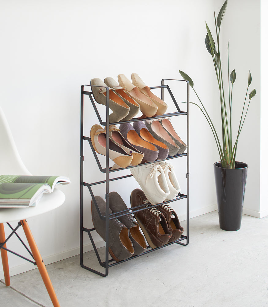 View 4 - Black Shoe Rack in entryway holding heels and sneakers by Yamazaki home.