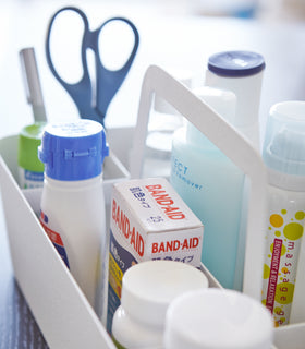 Side close up view white Storage Caddy holding first-aid materials by Yamazaki Home. view 4
