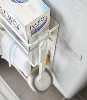 Close up aerial view of white Magnet Laundry Storage Pockets holding laundry items by Yamazaki Home. view 4