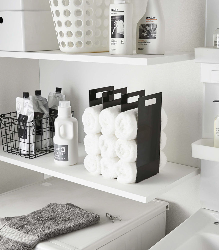 View 8 - Black Towel Storage Organizer holding towels in laundry room by Yamazaki Home.