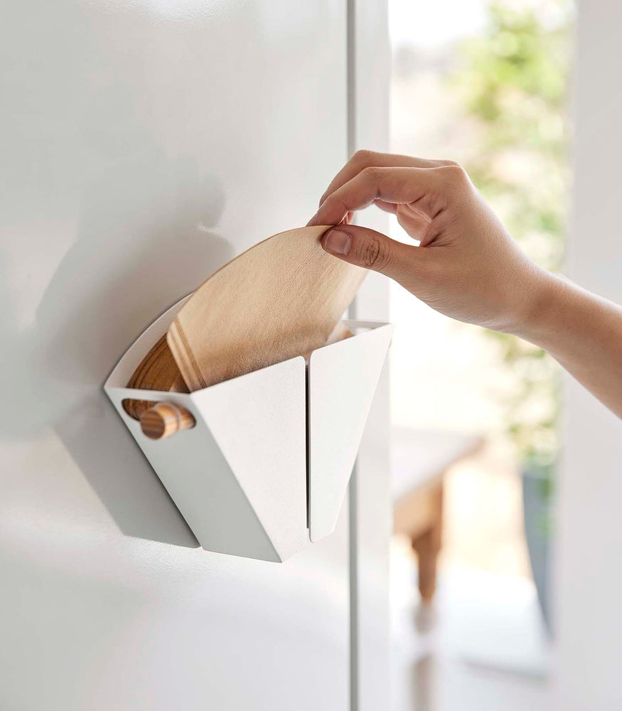 View 3 - Person grabbing size 04 coffee filter from Magnetic Coffee Filter Case by Yamazaki Home.
