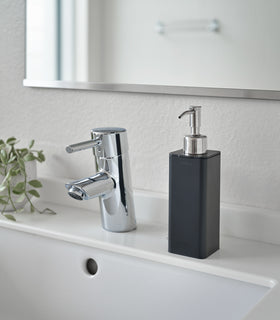 Black Hand Soap Dispenser on bathroom counter by Yamazaki Home. view 5