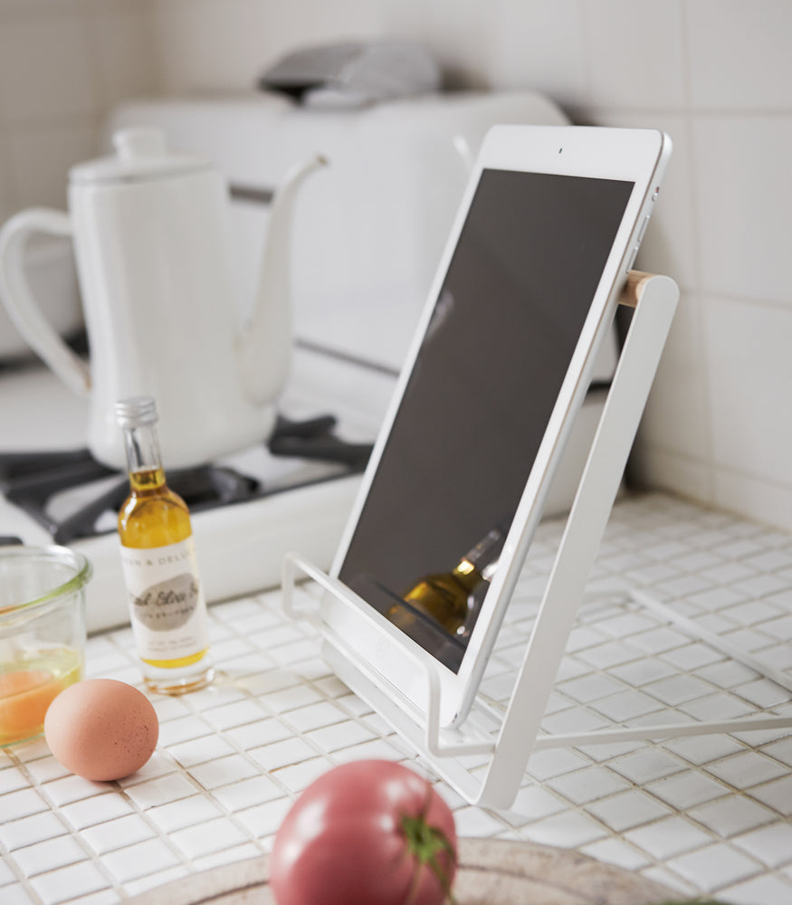 View 3 - Side view of white Tablet and Cookbook Stand holding a tablet by Yamazaki home.