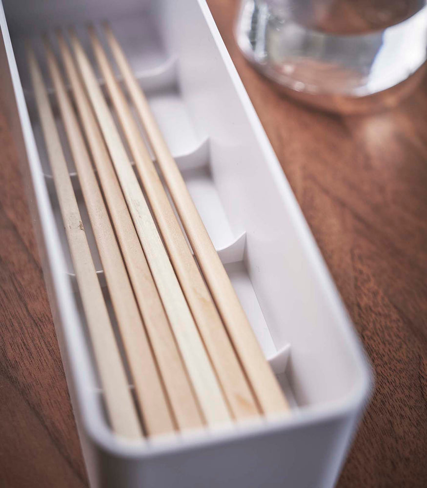 View 6 - Close up view of white Utensil Case holding chopsticks by Yamazaki Home.