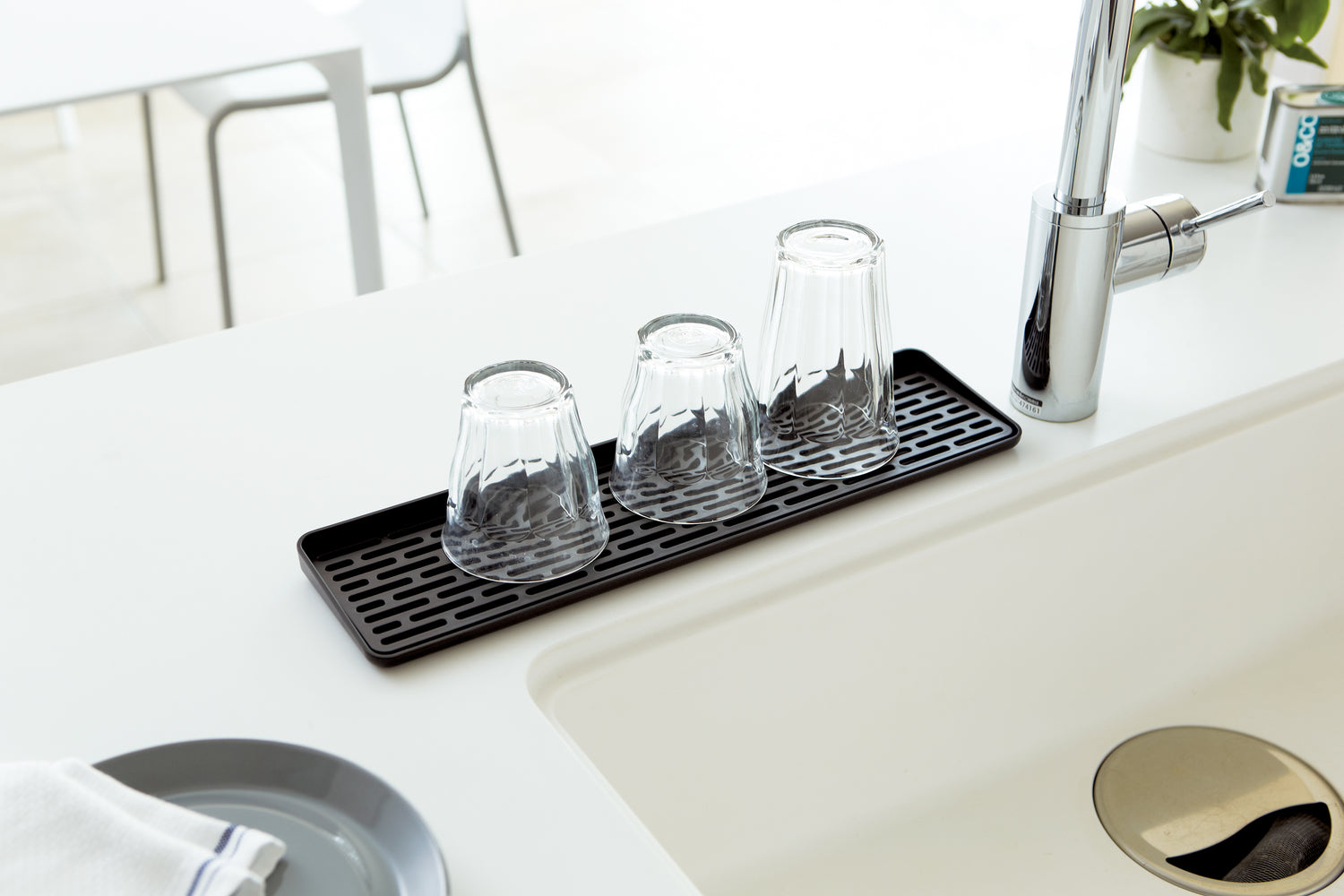 View 10 - Aerial view of Black Sink Drainer Tray holding glasses on kitchen sink counter by Yamazaki Home.