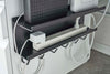 Close up view of Black Wall-Mount Cable and Router Storage Rack's hooks holding wires and power cord by Yamazaki Home.