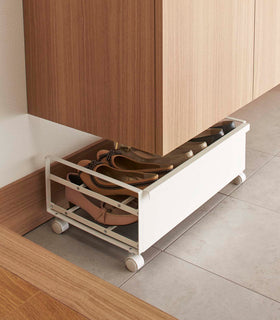 Back profile view of white Rolling Shoe Rack in bedroom by Yamazaki home. view 4