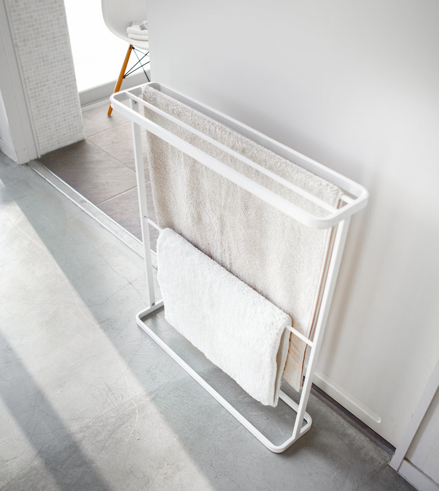 View 4 - Aerial view of white Bath Towel Hanger holding towels by Yamazaki Home.