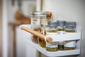 Close up side view of white Wall-Mounted Storage Caddy holding spices in kitchen by Yamazaki Home. view 5