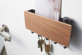 Close up view of walnut Magnetic Key Rack with Tray holding keys by Yamazaki Home. view 8