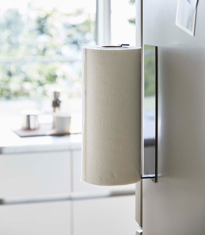 View 11 - Side view of Black Magnetic Paper Towel Holder holding towels in kitchen by Yamazaki Home.