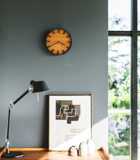 Front view of black Wall Clock on bedroom wall by Yamazaki Home. view 7