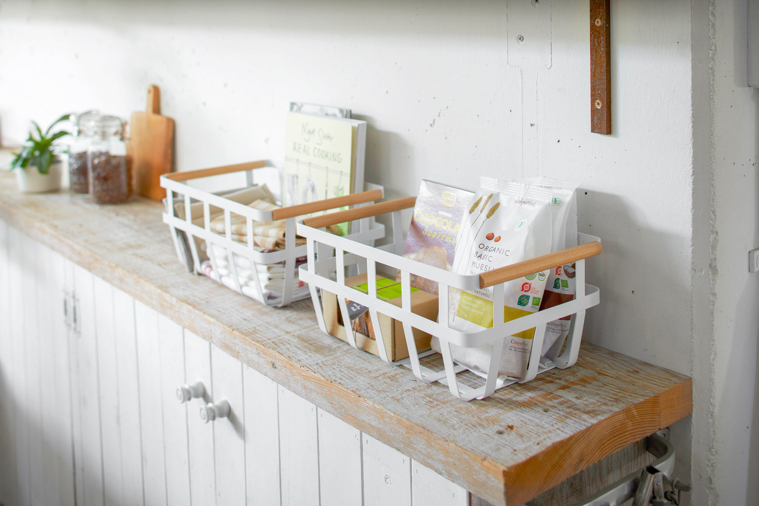 View 9 - Storage Basket containing food items on shelf by Yamazaki Home.
