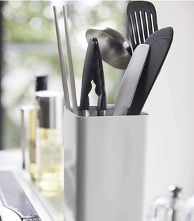 Close up side view of white Utensil Holder holding cooking utensils by Yamazaki Home. view 6