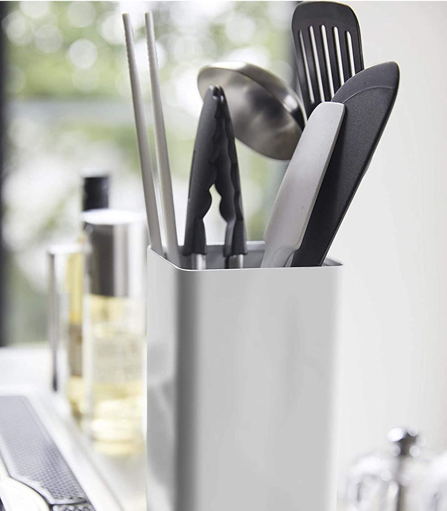 View 6 - Close up side view of white Utensil Holder holding cooking utensils by Yamazaki Home.