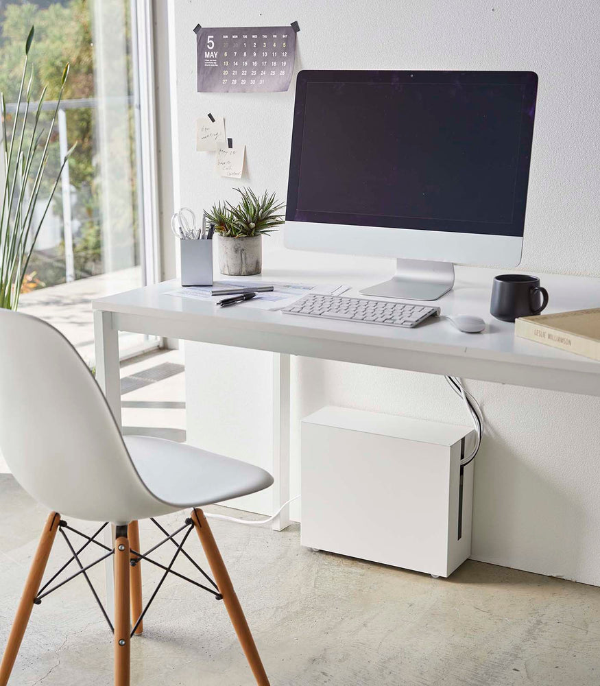 View 3 - White Rolling Cable Management Rack under desk in office by Yamazaki Home.