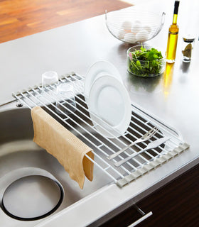 Over-the-Sink Dish Drainer holding dishes, cups, and silverware in kitchen by Yamazaki Home. view 5