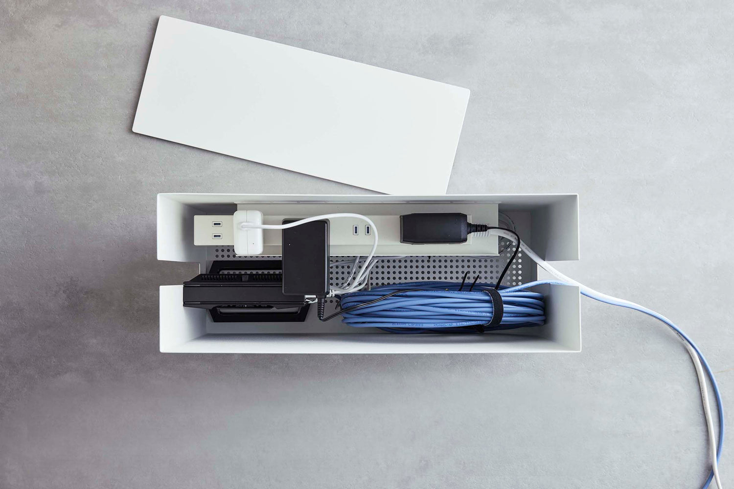 View 6 - Aerial view of white Rolling Cable Management Rack holding power strip by Yamazaki Home.