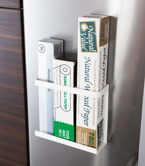 Front view of white Magnetic Wrap Holder containing cooking and baking paper by Yamazaki home.