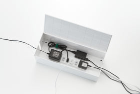 Aerial view of open white Cable Management Box holding wires and power strip on white background by Yamazaki Home. view 4