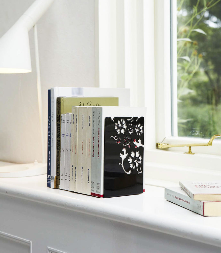 View 4 - Black Bookends holding books on shelf by Yamazaki Home.