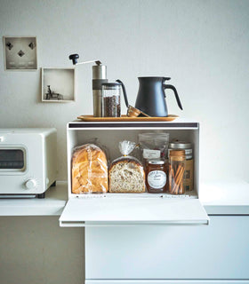 Front view of open white Bread Box holding bread and pantry items by Yamazaki Home. view 5
