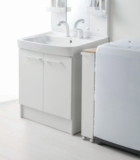 Side view of white Rolling Storage Cart in bathroom by Yamazaki Home. view 6