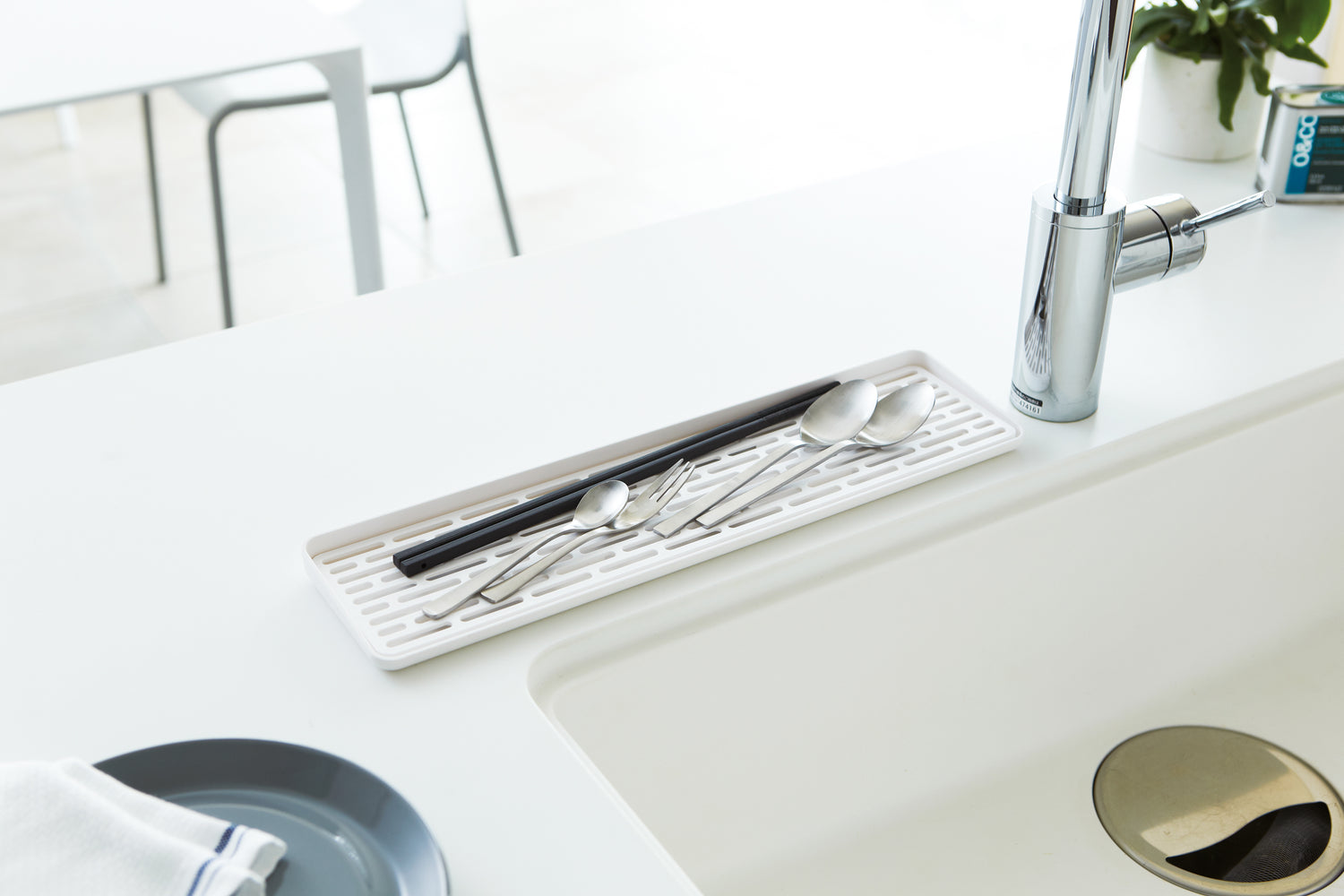 View 4 - White Sink Drainer Tray holding silverware on sink countertop by Yamazaki Home.