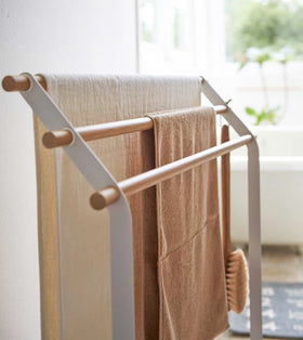 Close up side view of Bath Towel Rack holding towels in bathroom by Yamazaki Home. view 4