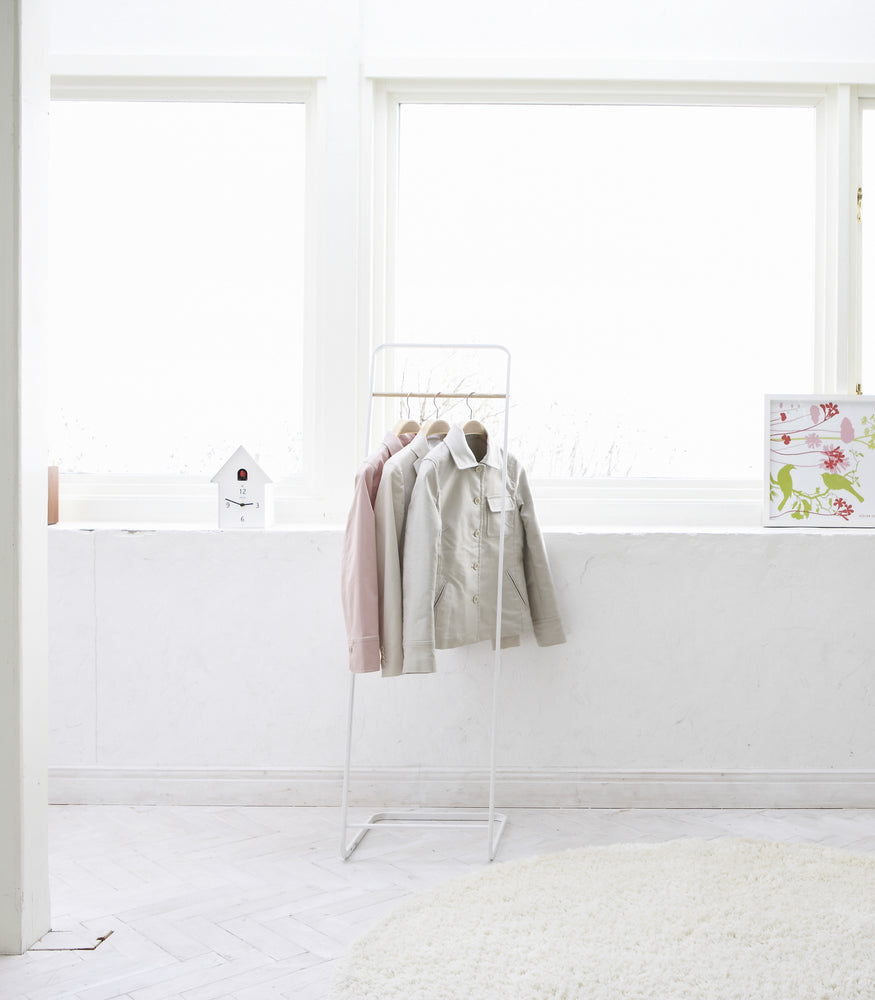 View 4 - Front view of white Clothes Rack holding jackets by Yamazaki Home.