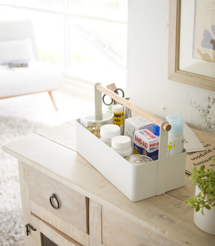 View 3 - White Storage Caddy containing first-aid items by by Yamazaki Home.