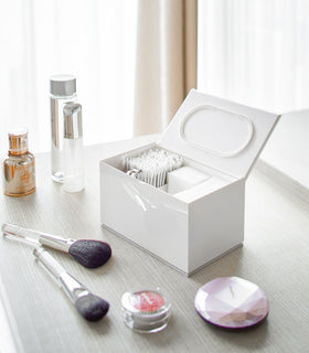 Open white Skincare Organizer holding cotton tips, cotton pads and nail clippers by Yamazaki Home. view 3