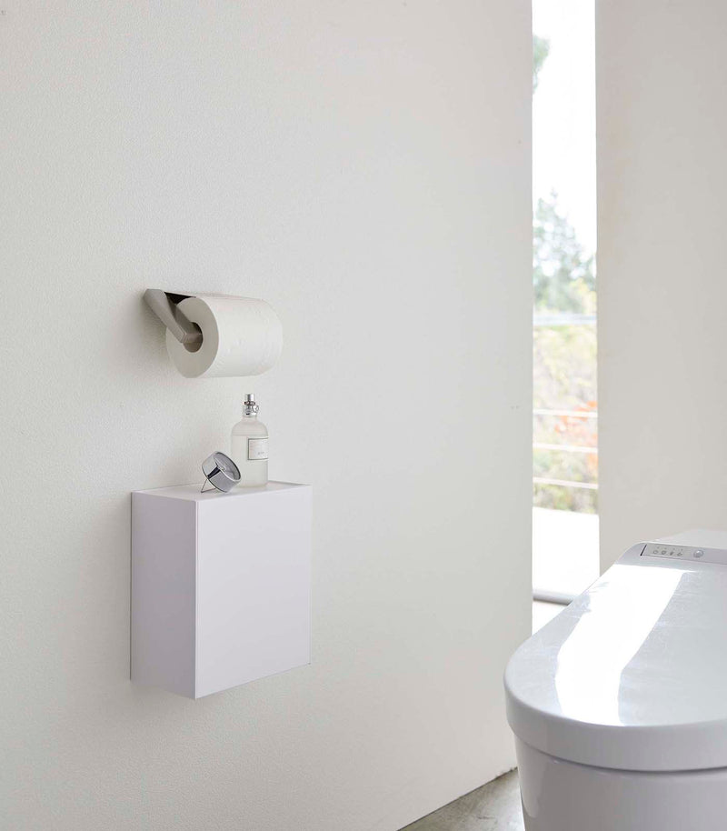 White Wall-Mount Storage on bathroom wall by Yamazaki Home.