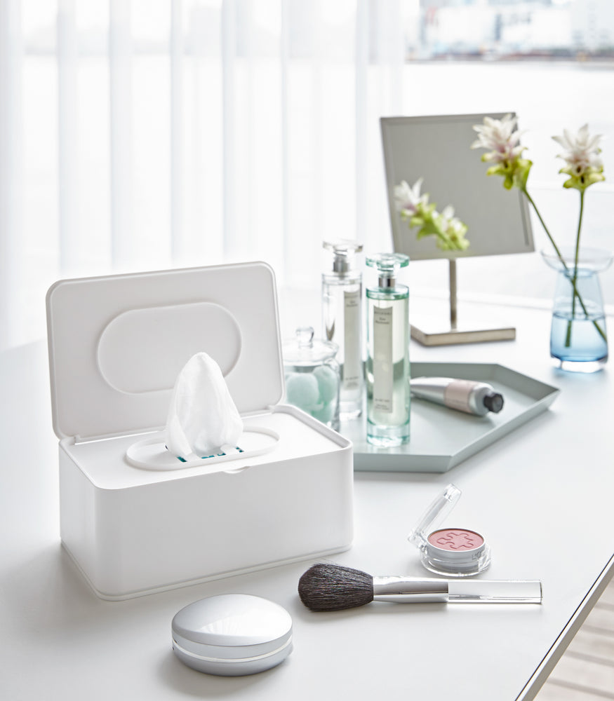 View 3 - Open white Wet Wipe Case holding wet wipes on vanity by Yamazaki Home.