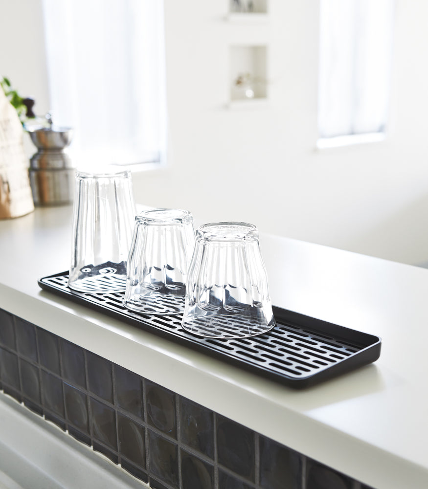 View 8 - Black Sink Drainer Tray holding glasses by Yamazaki Home.