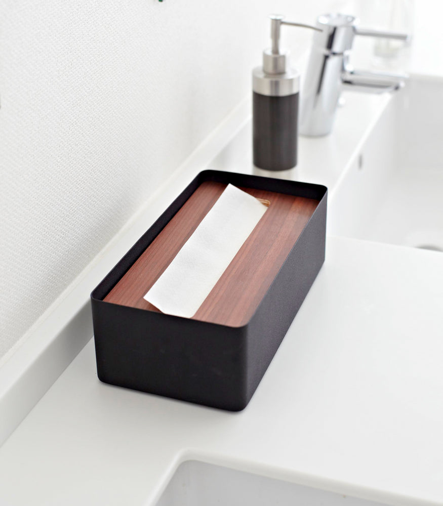 View 7 - Aerial view of black Tissue Case on bathroom sink counter by Yamazaki Home.