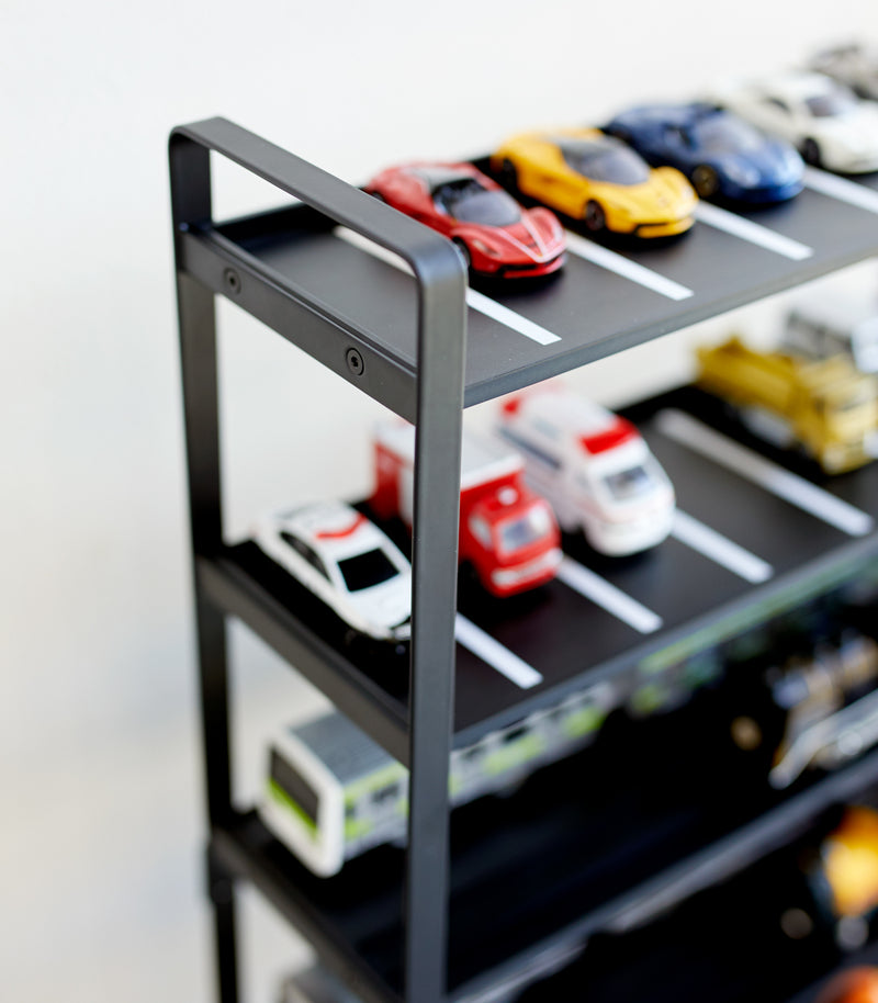 Close up top view of black Kids' Parking Garage displaying toy cars by Yamazaki Home.