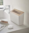White Countertop Waste Bin on bathroom sink countertop by Yamazaki Home.