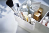 Close up view of white Makeup Organizer attachment holding makeup by Yamazaki Home.
