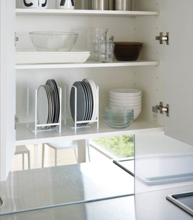White Dish Storage Rack holding plates in kitchen cabinet by Yamazaki Home. view 4