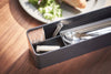 Close up end view of black Utensil Case holding utensils on table by Yamazaki Home.