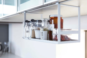 White Slim Dish Rack on kitchen counter holding plates and utensils by Yamazaki Home. view 4