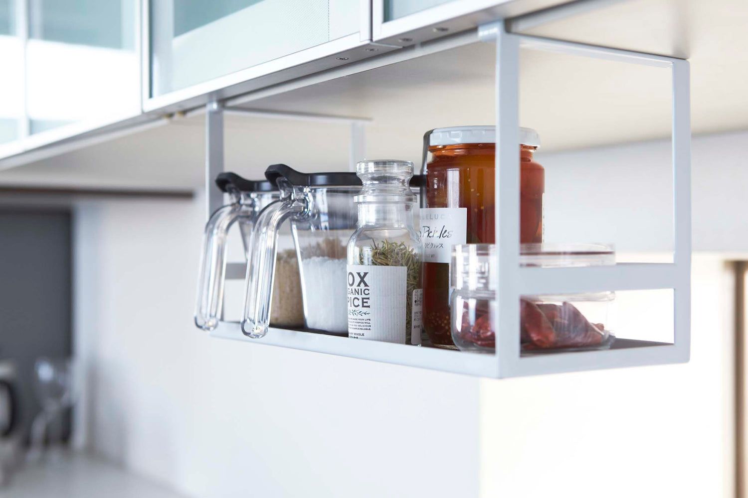 View 4 - White Slim Dish Rack on kitchen counter holding plates and utensils by Yamazaki Home.