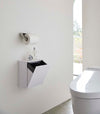 White Wall-Mount Storage open and holding trash bag on bathroom wall by Yamazaki Home.