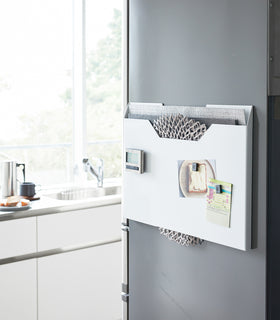 White Magnetic Placemat Organizer on kitchen fridge by Yamazaki home. view 2