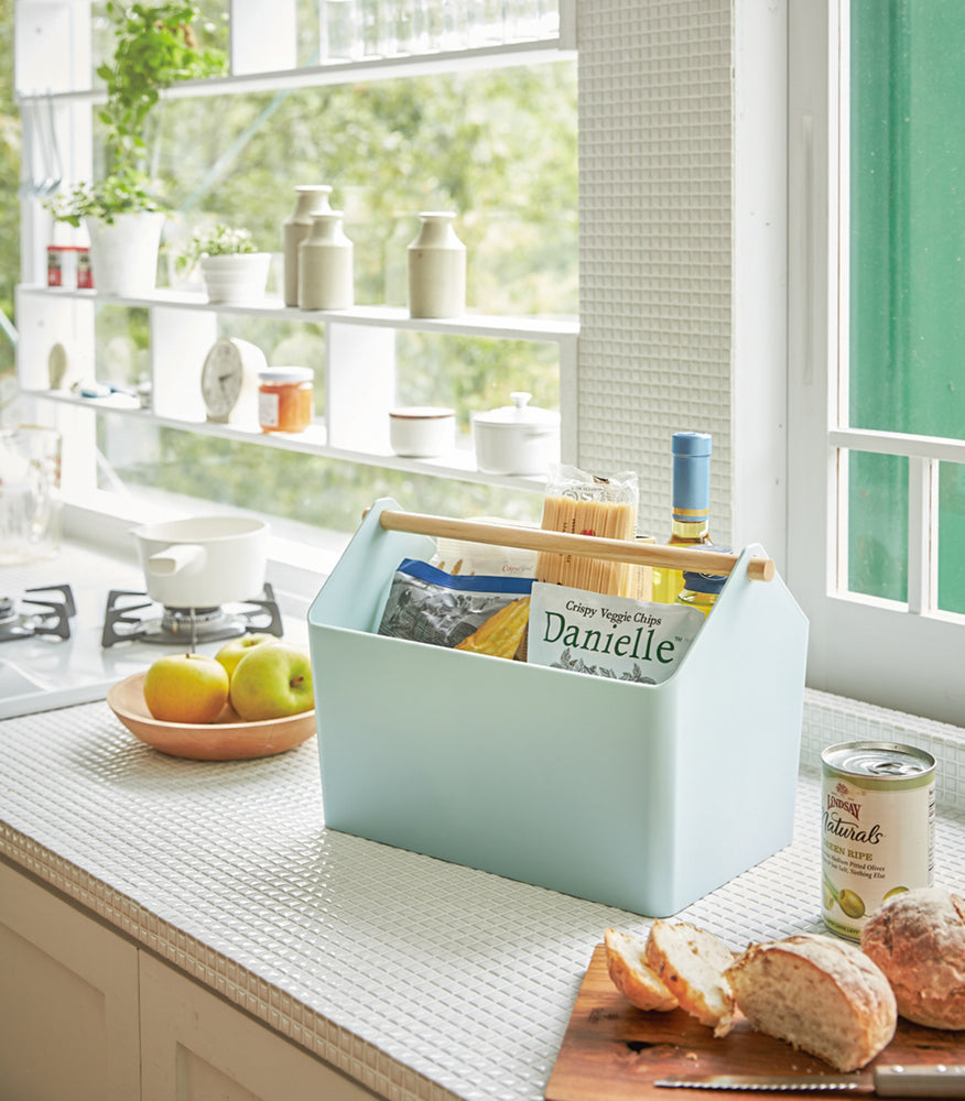 View 10 - Blue Storage Caddy holding food and drink items on kitchen countertop by Yamazaki Home.