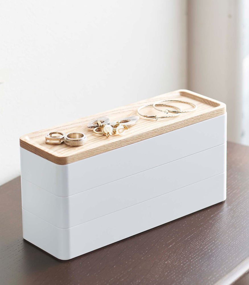 View 2 - Closed white Stacking Watch and Accessory Case with jewelry on top