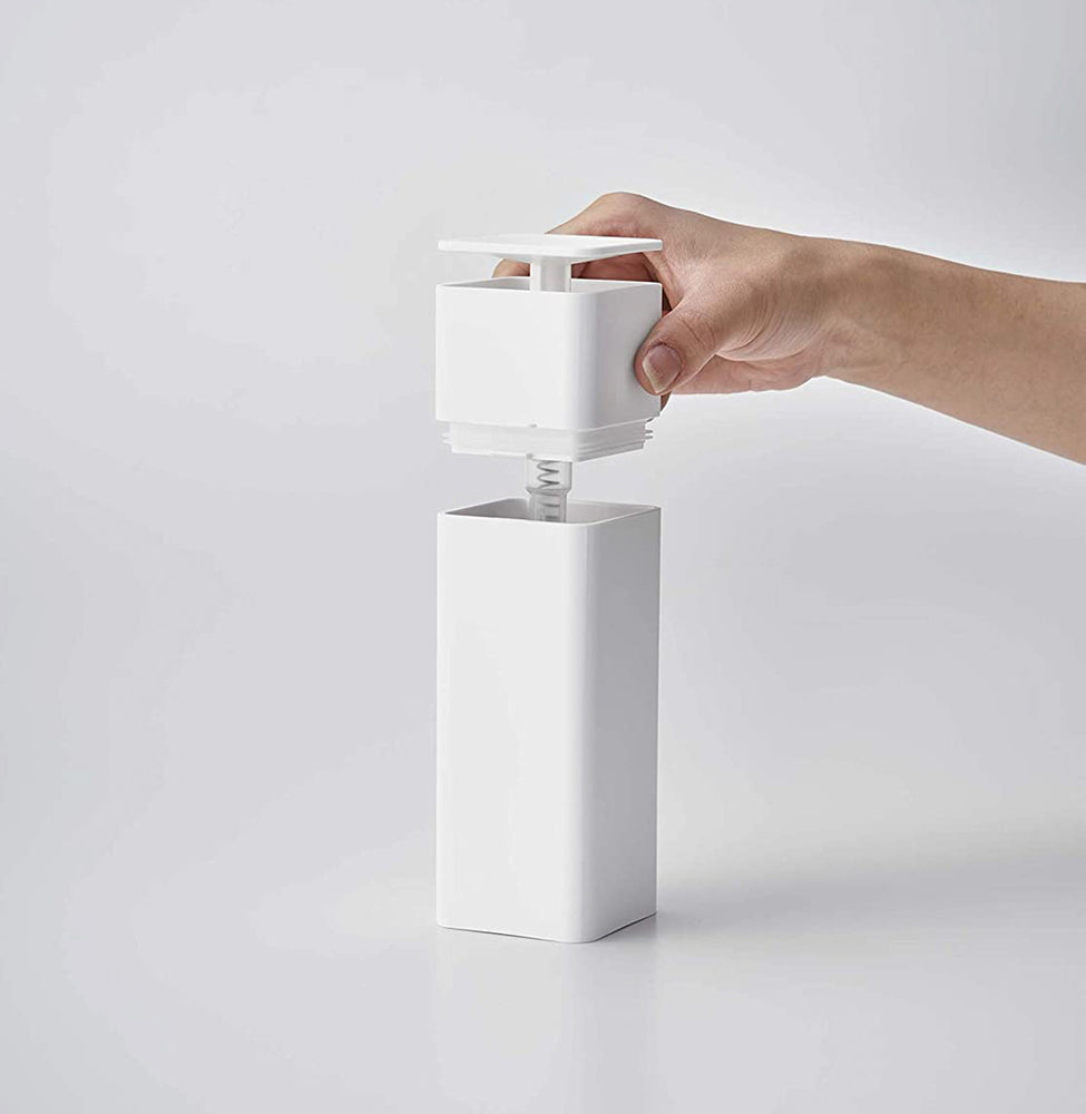 View 5 - Front view of white One-Handed Push Soap Dispenser with top removed on white background by Yamazaki Home.