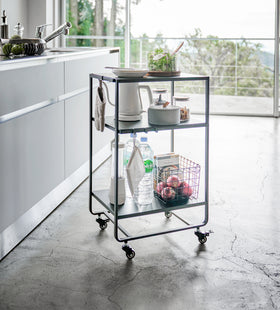 Black Rolling Utility Cart displaying kitchen items in kitchen by Yamazaki Home. view 8