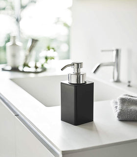Black Foaming Soap Dispenser on bathroom sink counter by Yamazaki Home. view 7